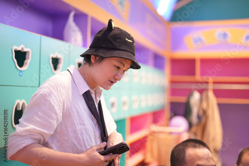 Photography Chinese children and adults enjoy talking in a colorful locker room at an indoor play area