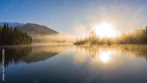 Tranquil Misty Lake with Mountain Reflections at Sunrise