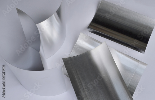 aluminum sheet metal on white surface. curved material