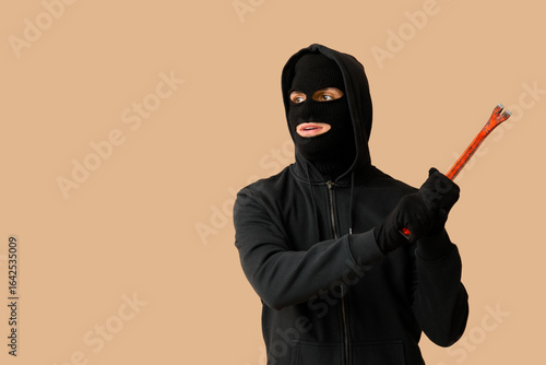 Male thief with crowbar on ...