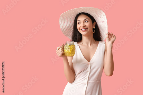 Wallpaper Mural Beautiful young happy woman with mason jar of lemon infused water on pink background Torontodigital.ca