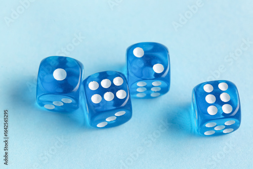 Four translucent blue dice ...