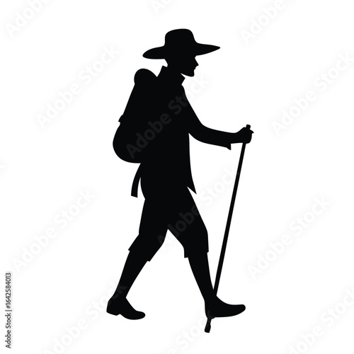 Silhouette of a hiker with a backpack and walking stick