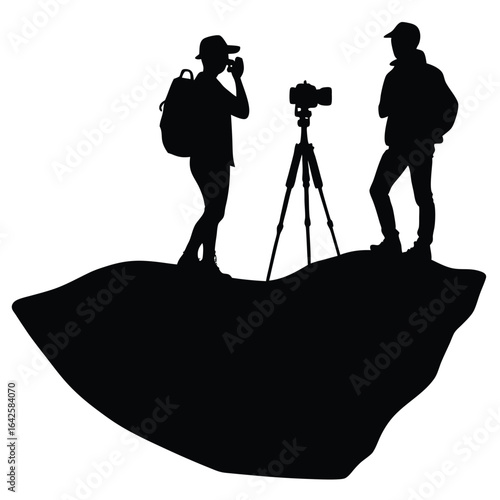 Silhouetted photographers on rocky outcrop people camera