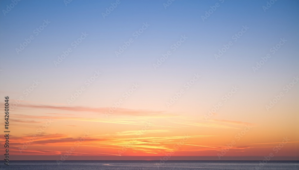Fototapeta premium A serene boat glides across the shimmering water, silhouetted against a vibrant sunset, with hues of orange, pink, and purple reflecting on the waves.