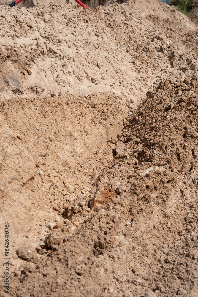 close-up view of excavated earth in construction site, featuring uneven terrain and distinct soil textures under bright natural sunlight, dig, process, trench, daytime, exposing, field, section close-up view of excavated earth in construction site, featuring uneven terrain and distinct soil textures under bright natural sunlight, dig, process, trench, daytime, exposing, field, section