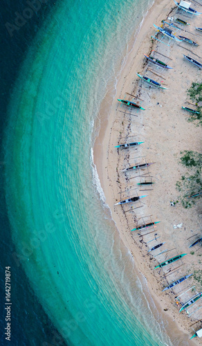 Tropical seaside paradise with colorful boats and lush greenery.