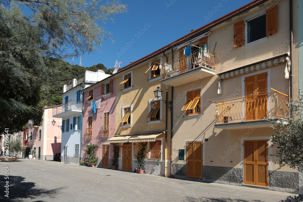 Fototapeta premium Old street in Italian countryside near sea. Traditional building. Sun day. Entrance, window to house. Nature and sky.