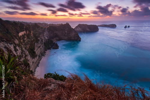 Sunrise view of scenic cliff islands and Diamond Beach at Nusa Penida, Indonesia. Crystal-clear turquoise water of the ocean. Wonderful sea view. Diamond Beach is a popular tourist attraction of Asia.
