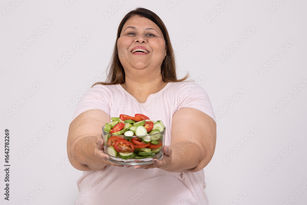 Joyful indian overweight fat woman holding bowl of healthy salad, dieting for weight loss, fitness and health care, isolated over white background, Copy Space Joyful indian overweight fat woman holding bowl of healthy salad, dieting for weight loss, fitness and health care, isolated over white background, Copy Space