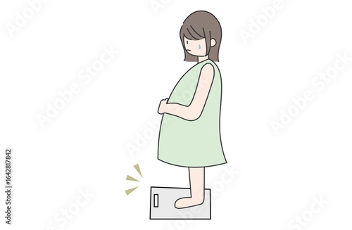体重計に乗って予想以上に太っていて焦る妊婦