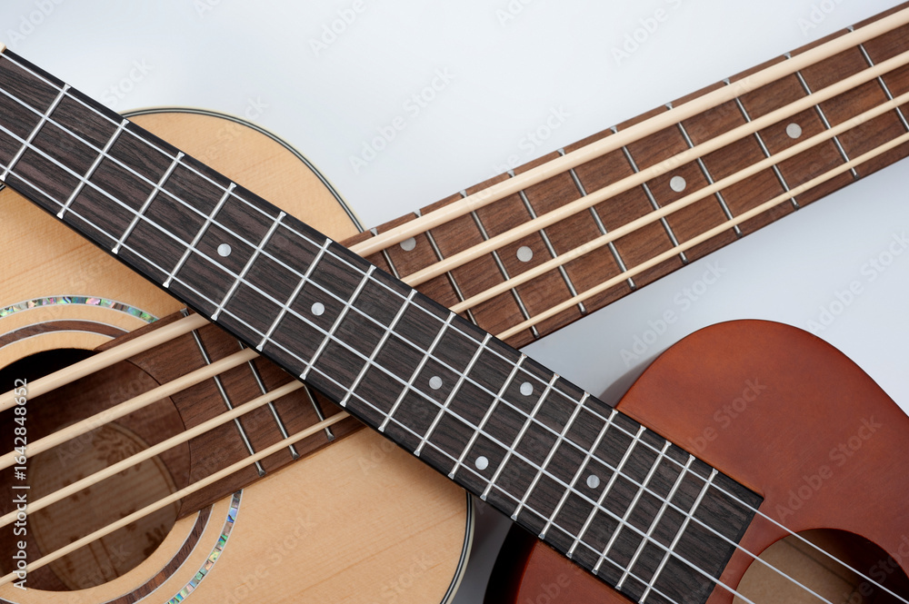 Fototapeta premium Four-string bass ukulele with wooden body and built-in tuner and pickup.
