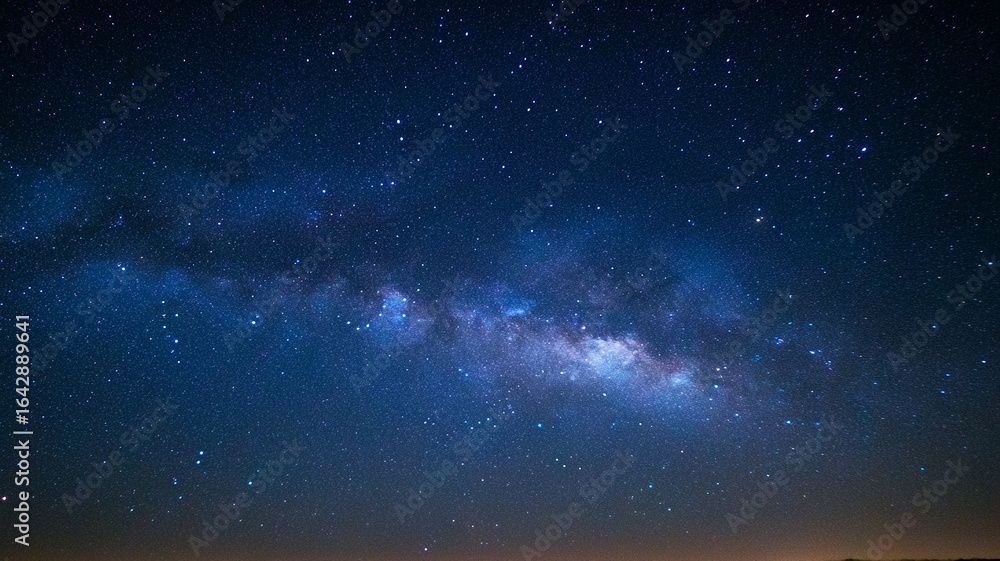 Obraz premium The night sky is filled with stars and the Milky Way