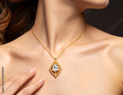 Close-up of a woman's d?colletage, adorned with a gold necklace featuring a large, clear gemstone pendant