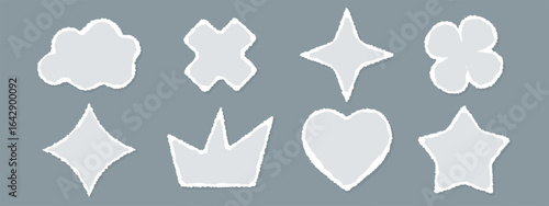 A set of cut out paper shapes with rough, torn edges. Stickers include hearts, crowns, clouds, and stars. Vector templates.