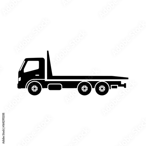 A black silhouette of a flatbed truck with three axles on a white background