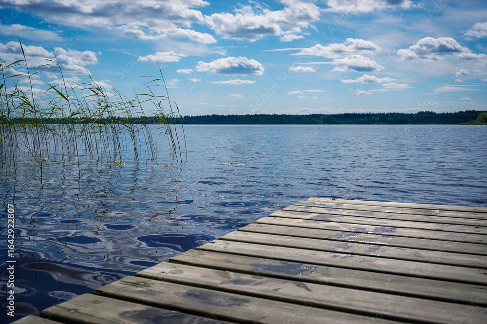 Fototapeta premium Beautiful lake view with wooden pier on the lake