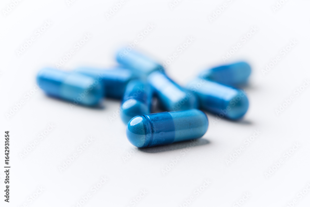 Hyaluronic acid tablets. Hyaluronic acid helps skin stretch and flex and reduces skin wrinkles. Bright paper background. Soft focus. Close up. Copy space Hyaluronic acid tablets. Hyaluronic acid helps skin stretch and flex and reduces skin wrinkles. Bright paper background. Soft focus. Close up. Copy space