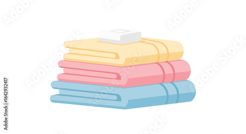 A colorful stack of clean, freshly laundered pastel towels with a bar of soap, representing hygiene and bath essentials.