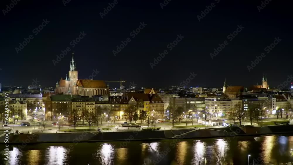 Nighttime cityscape of a vibrant urban area with illuminated buildings and reflections on water Nighttime cityscape of a vibrant urban area with illuminated buildings and reflections on water
