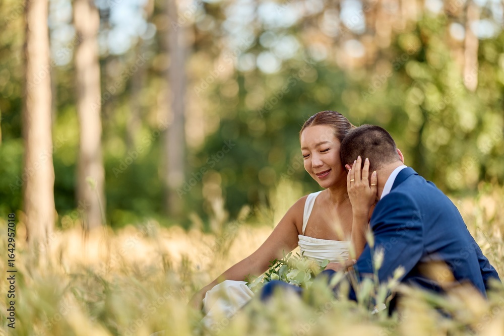Fototapeta premium Romantic Outdoor Wedding Couple Sharing Intimate Moment in Scenic Nature Setting