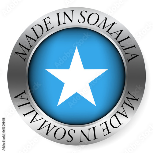 Made in Somalia button icon. Circular emblem with metallic border, glossy central flag, and bilingual label indicating product origin and international manufacturing identity.