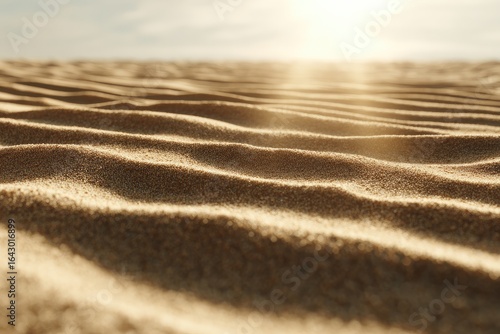 Close-up view of rippled desert sand, sunbeams