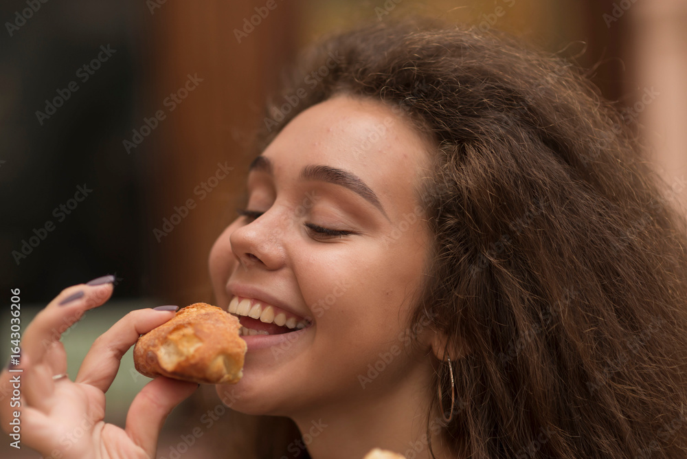 young girl bites baguette with appetite young girl bites baguette with appetite