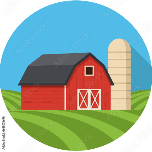 Vibrant red barn with silo set against a clear blue sky and green fields