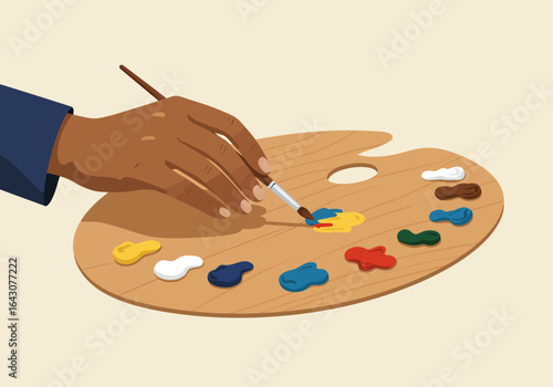 Dark-skinned hand mixing paints on a wooden artists palette.