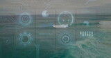 Displaying holographic interface panels floating above open sea, with data charts and circuits