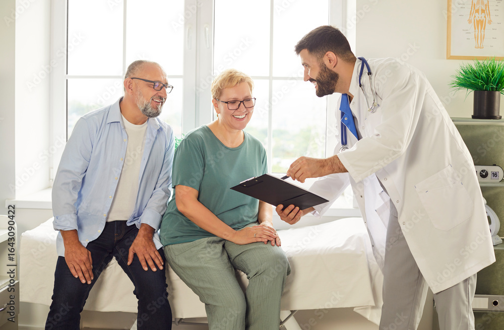 Obraz premium Elderly couple talking with doctor in a bright office, smiling and discussing health. Professional consultation brings comfort. Caring conversation builds trust and understanding. 