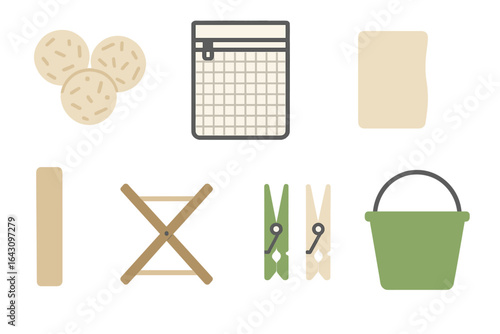 Variety of household items arranged neatly including cookies, a grid, cloth, clothes dryer, clips, and a bucket