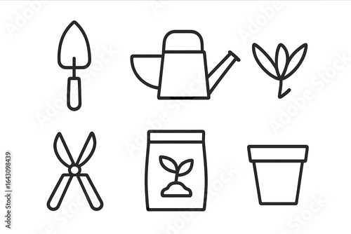 Gardening tools and supplies laid out for planting in a home garden setting during daylight hours
