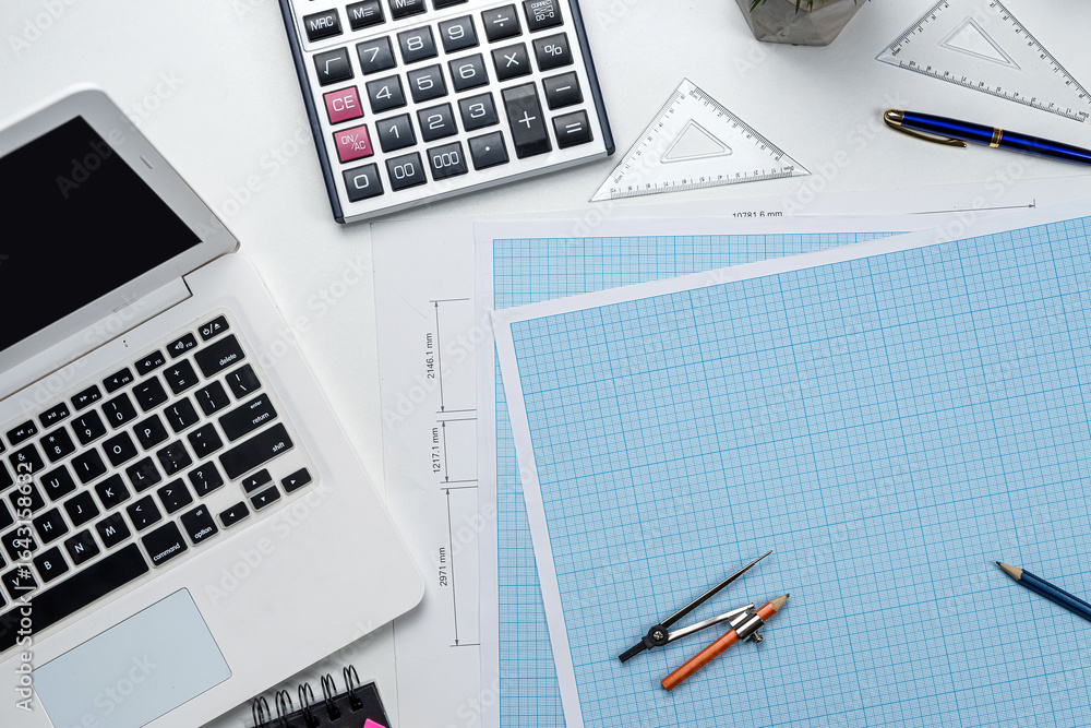 House plan blueprint paper with laptop pencil calculator on architecture office desk House plan blueprint paper with laptop pencil calculator on architecture office desk