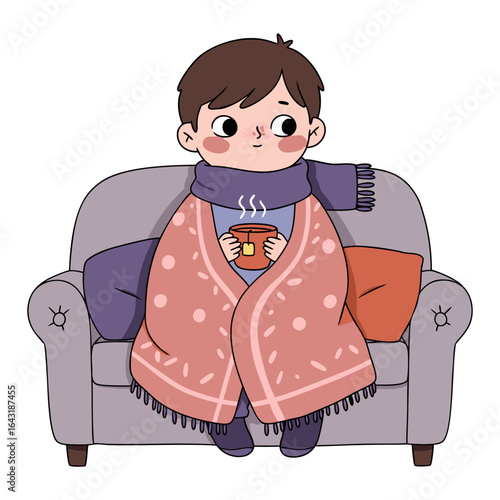 A young boy feeling unwell on a sick day, resting on the sofa wrapped in a cozy blanket and holding a hot drink.