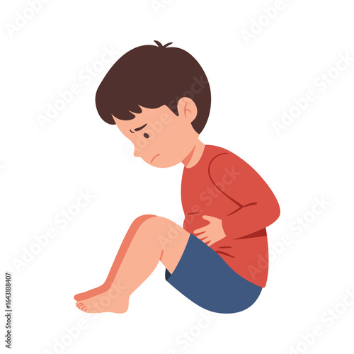 Unwell little child suffering from stomach pain, holding his belly. A sad boy with a stomachache due to illness or cramps.