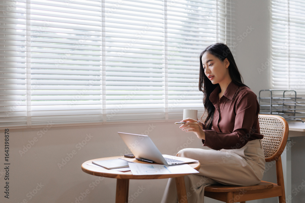 Businesswoman working from home having a video call on laptop Businesswoman working from home having a video call on laptop