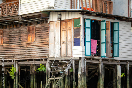 Photography Wooden houses along the Khlong Mong canal on the Thonburi side of Bangkok, Thail