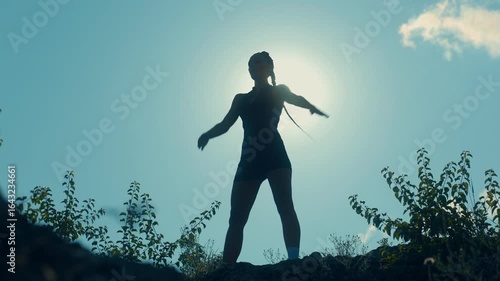 Wallpaper Mural Silhouette of graceful woman doing a strong stretch at outdoor sunset Torontodigital.ca