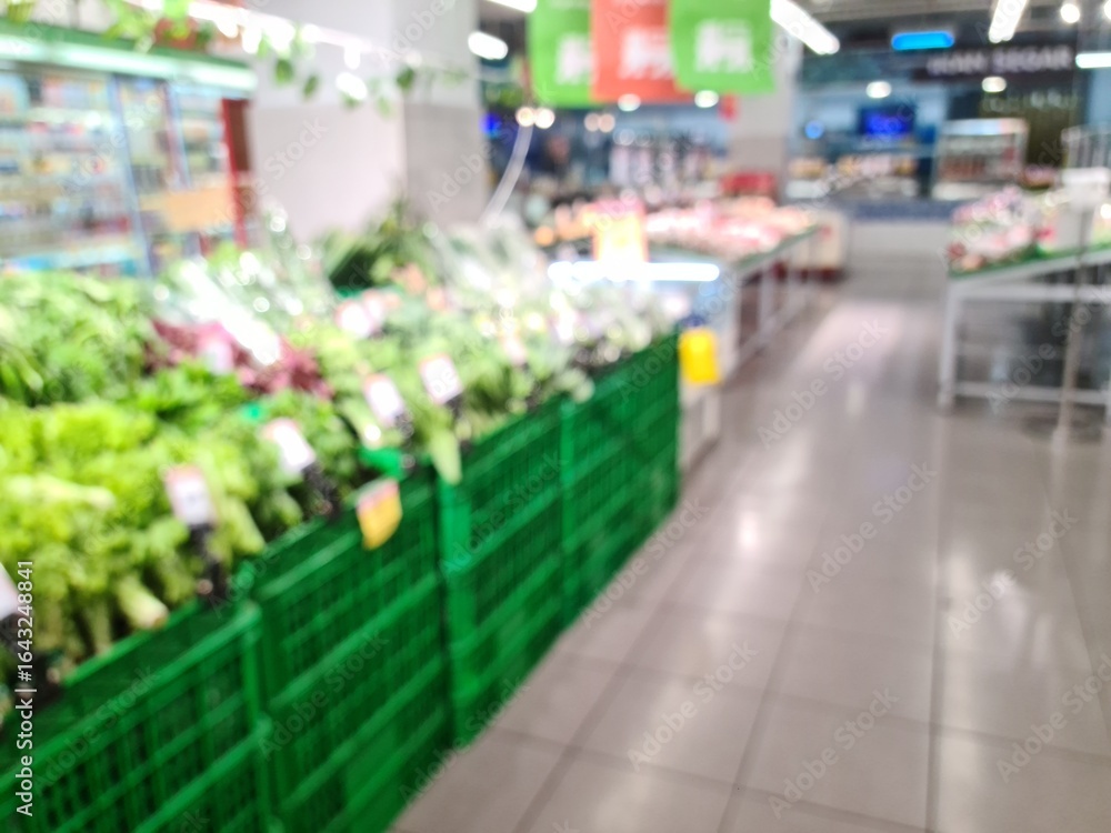 Fototapeta premium Defocused vegetable section in a modern market