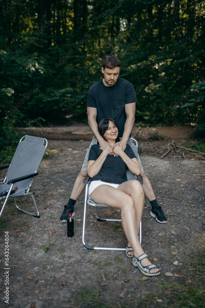 Adult couple relax at nature near lake at summer Adult couple relax at nature near lake at summer