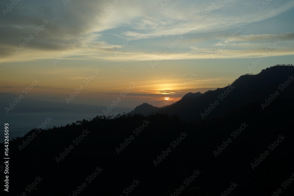 Fototapeta premium Sunrise over Mountains Silhouette Nature with Sky, and Scenery.