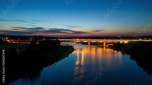 Serene Sunset: Bridge, River, and Twilight Glow