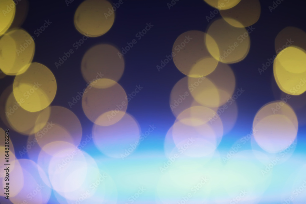 Fototapeta premium Abstract bokeh background. Golden bokeh circles on dark blue background. Layer overlay.