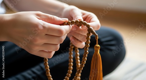 Hands delicately counting prayer beads in quiet contemplation and spiritual connection