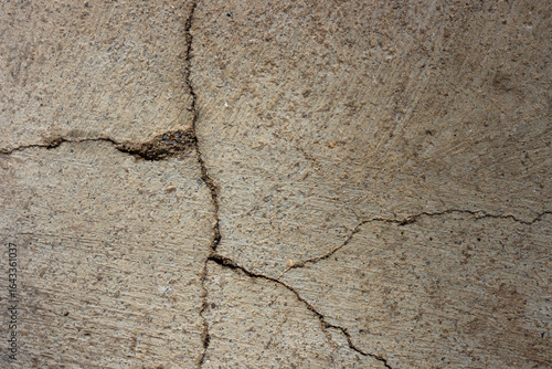 Close-up of cracked and rough concrete for overlay background.