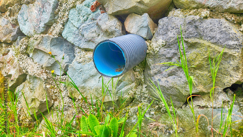 rainwater drainage pipes between the masonry stone walls