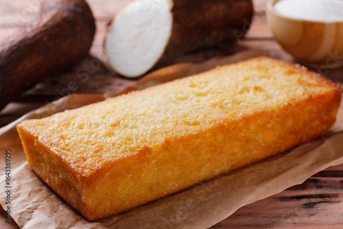 Traditional homemade cassava cake whit coconut on a rustic wooden table