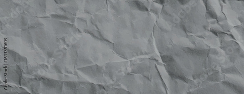 Gray crumpled paper background, textured with wrinkles. The background is gray, adding a rustic, artistic feel. Paper texture background vector. Gray background.